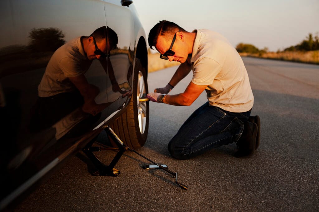 man taking off car wheel